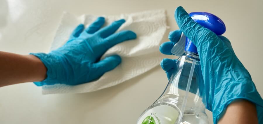 Cleaning a surface using disinfectants.